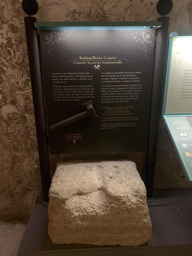 Coquina block on display inside the fort's room. It is worn down from being touched.