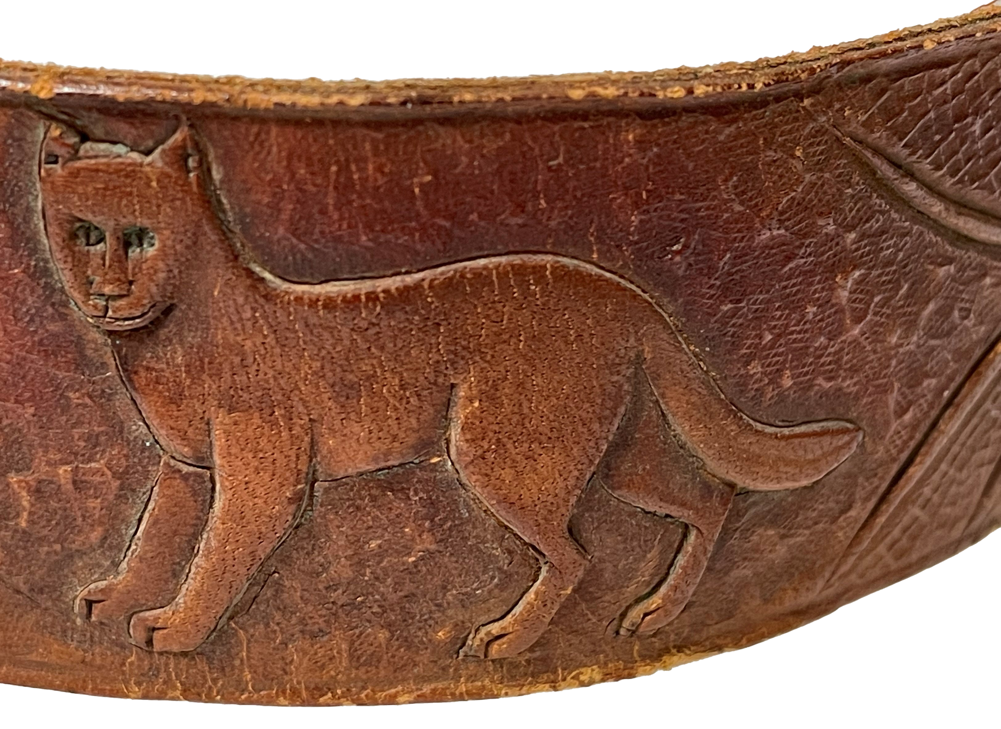 Close up of a cougar etched on a band of leather.