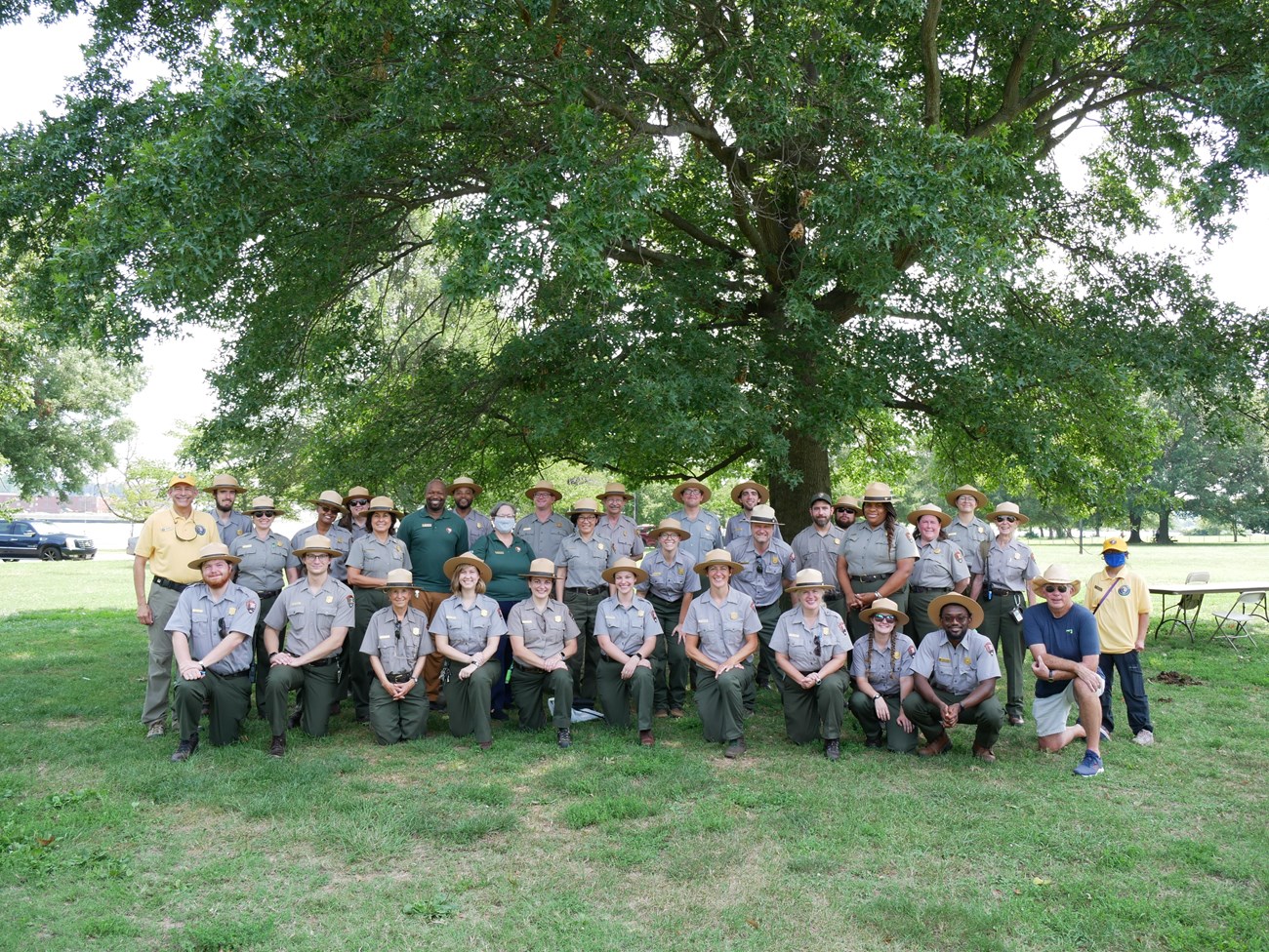 National Mall staff at Hains Point Community Day. 34 National Park Service works standing or kneeling under a large tree.