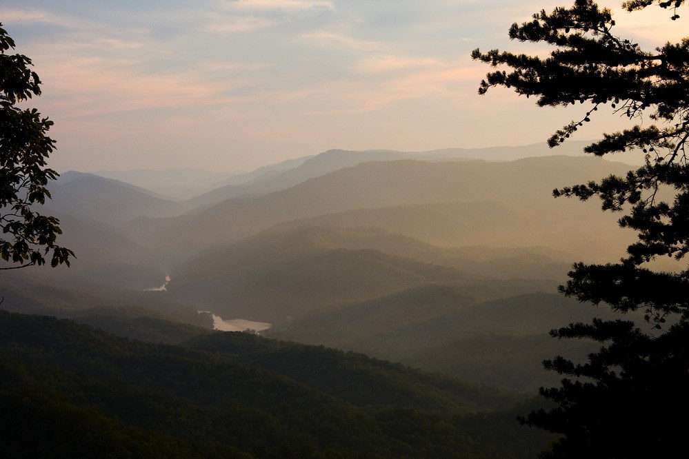 Pinnacle Overlook An overlook view of rolling mountains with green trees and fog.