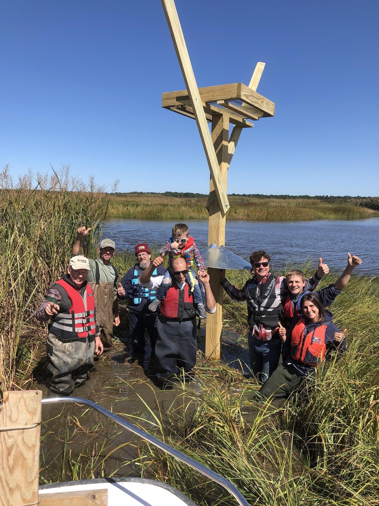 CU Maurice River volunteers celebrate after erecting of an osprey platform.  Stewardship photo from CU Maurice River library.