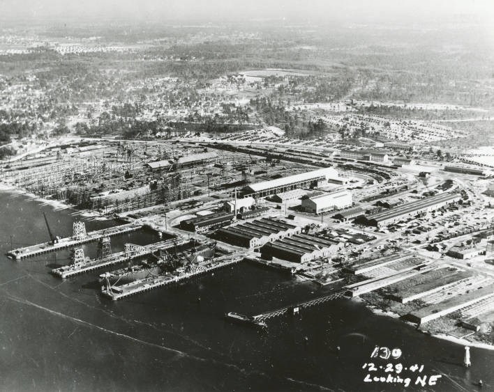 Aerial of the shipyard, December 29 1941. The shipyard looks to be about two or three blocks with a marina attached to it. The rest of the background is an aerial view of Wilmington.
