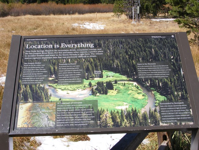 Interpretive sign about weather station An interpretive sign at Devils Postpile National Monument explains why the location of the weather station in Soda Springs Meadow is important. A photo of the meadow and the river winding through it is on the sign along with text.
