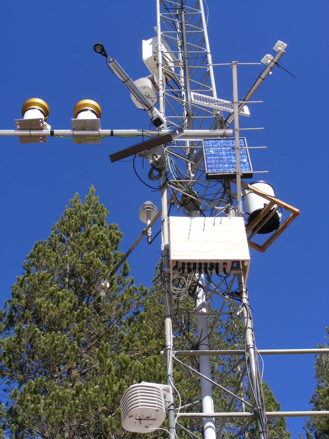 Weather monitoring station at Devils Postpile National Monument View looking upward at the metal tower and instruments of a weather monitoring station.