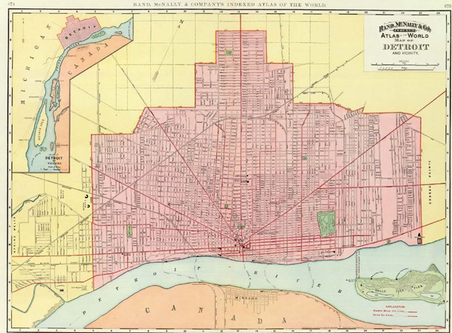 A map in pink, yellow, blue, and orange showing a large city area abutting a river. Text in the top right corner reads "Rand McNally & Co Atlas of the World, Map of Detroit and Vicinity"