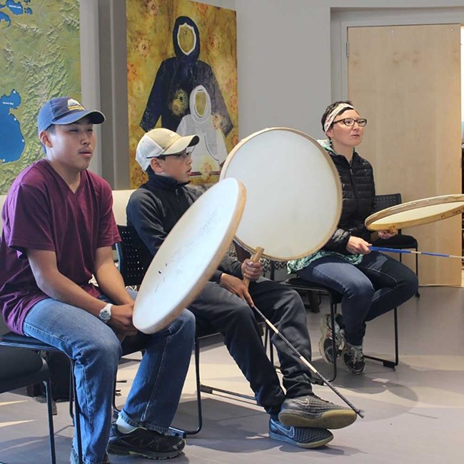 Youth learn traditional drumming.