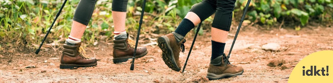 Travel and Camp on Durable Surfaces a close up of two hikers boots with hiking poles on a trail
