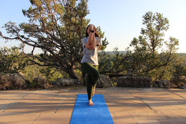 A park ranger in a yoga pose