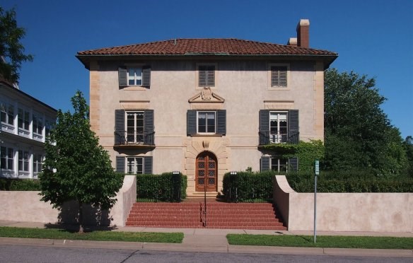 elizabeth_c__quinlan_house house that sits right by a street- the house is concrete white and a red roof