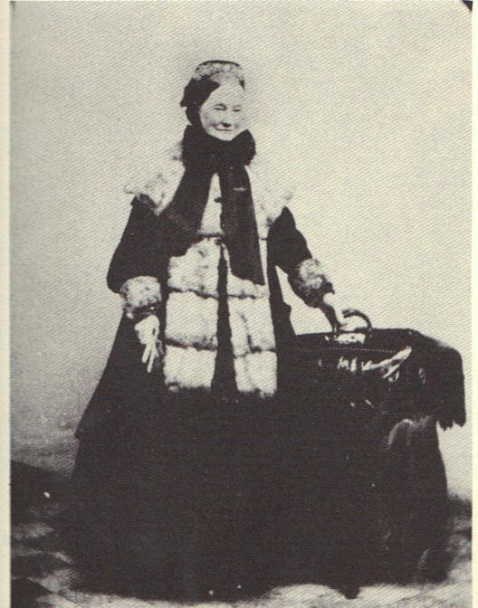 old woman wearing a white and black checkered dress