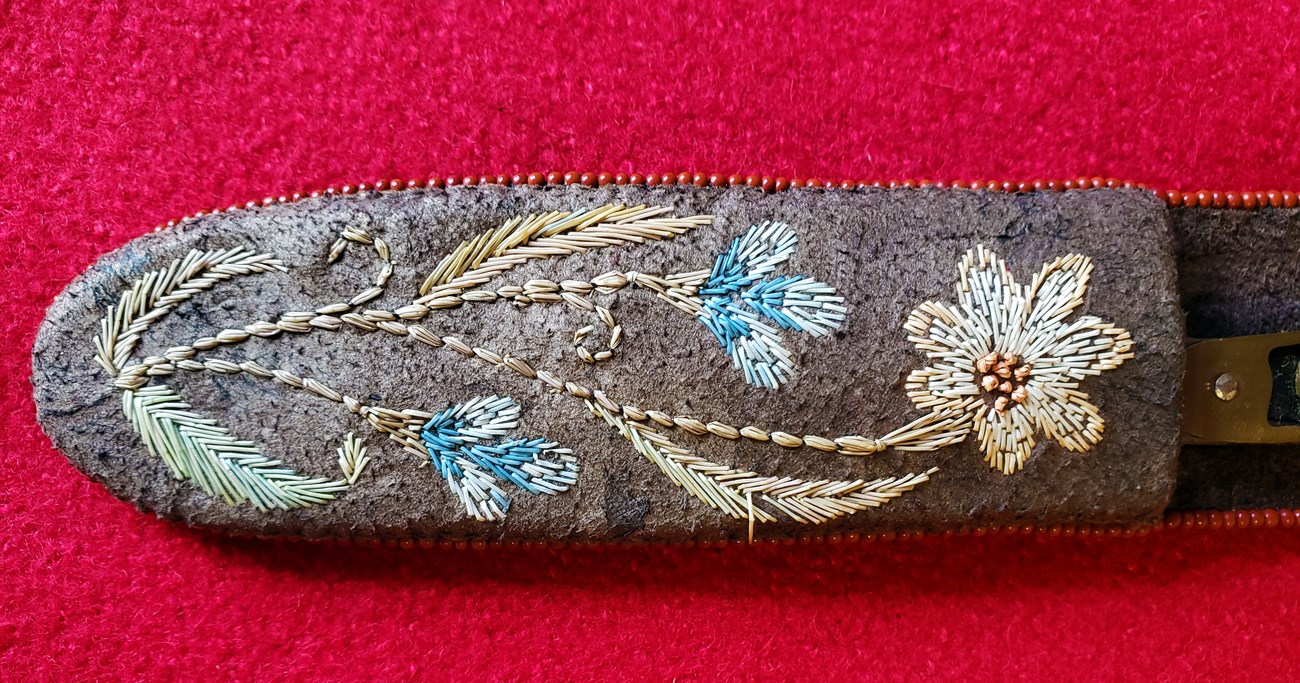 A knife sheath with floral design moose hair embroidery.