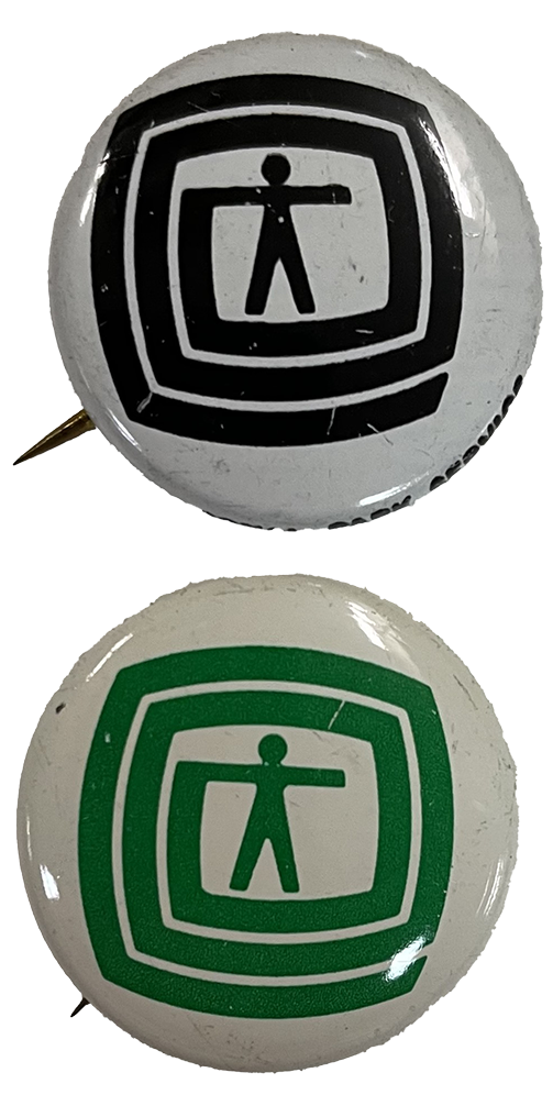 Environman pins Two round metal pins with figure of a man surrounded by linear circles