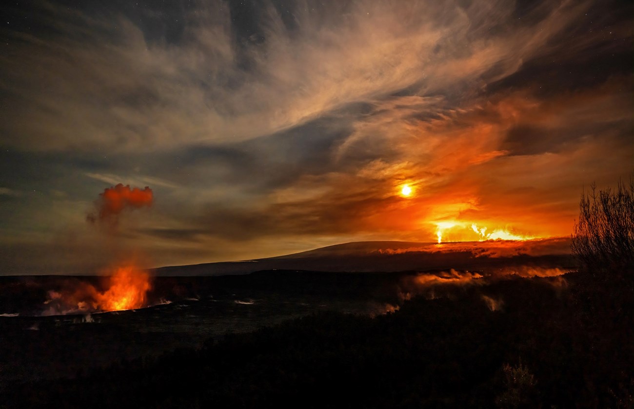 Mauna Loa and Kilauea erupting NPS Janice Wei Boldly glowing in the moonlight, Mauna Loa and Kīlauea volcanoes erupt
