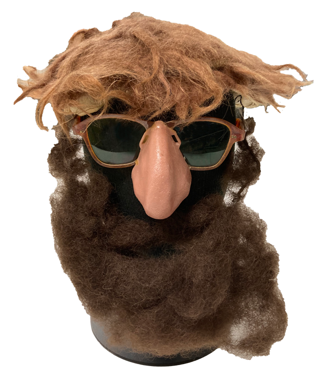 The face of One Lick Evergreen sunglasses, fake nose, red wig, and brown beard on a mannequin head