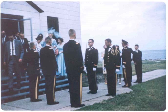 patrons exit a chapel past a line of uniformed soldiers