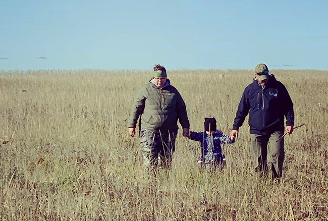 A family walking in an open area.