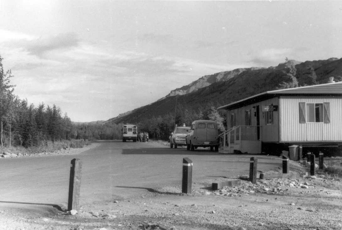 vehicles near a one-story trailer style building