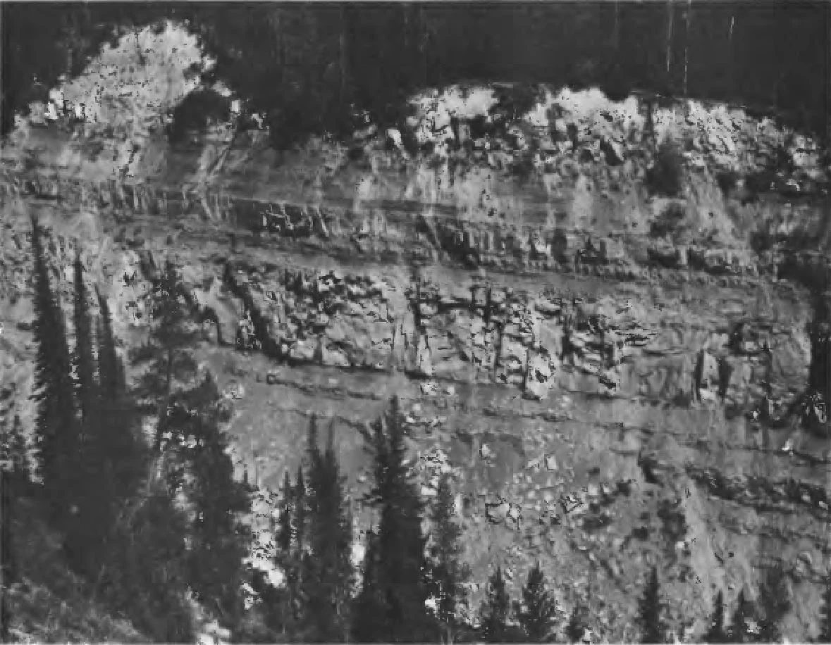figure26 old black and white photo of rock bands in a cliff