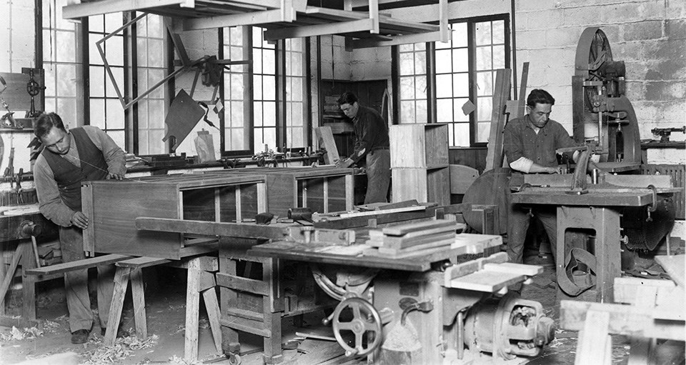 Val-Kill Furniture Shop Three men working in a wood shop.