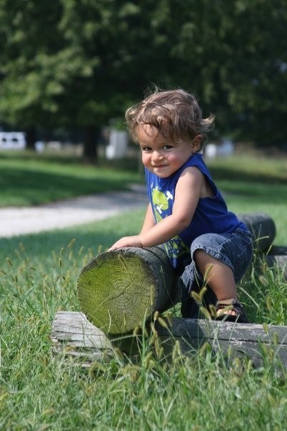 A child climbs on a log