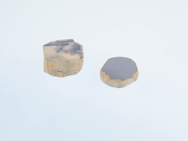 gaming-pieces two circular pieces of blue ceramic on a white background
