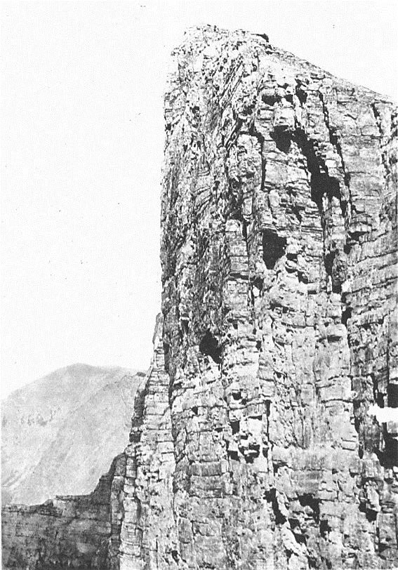black and white photo of a tall rock spire