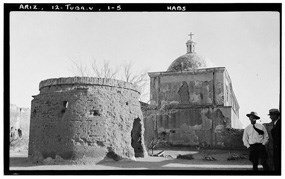 black and white photo with round mortuary chapel and man in near field