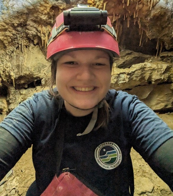 heather Heather in Lehman Caves smiling into the camera with soda straws in the background.