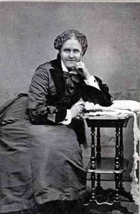 a black and white photo of a woman leaning on her hand