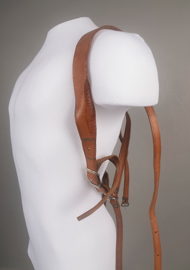 Leather backpack straps fitted to a mannequin torso