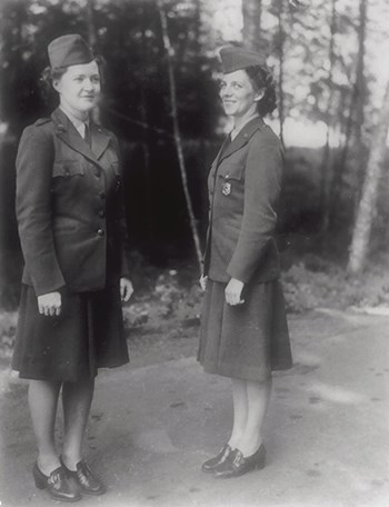 hfca_1607_brunes_catherine_and_hilton_barbara_dickinson_1950_u Two women stand on a dirt path showing the new women's NPS uniform.