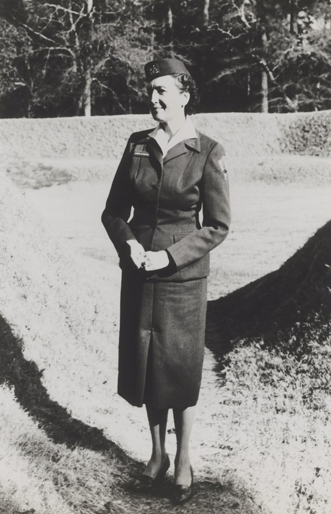 Louise Meekins in 1961. Louise Meekins wearing her 1961 NPS uniform and cap stands in a field.