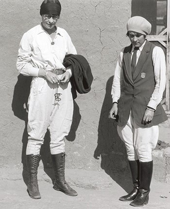 Polly Mead (right) and her sister at Grand Canyon.  Both women are wearing white coveralls, knee boots and hats. Polly's badge can be seen attached to her vest.