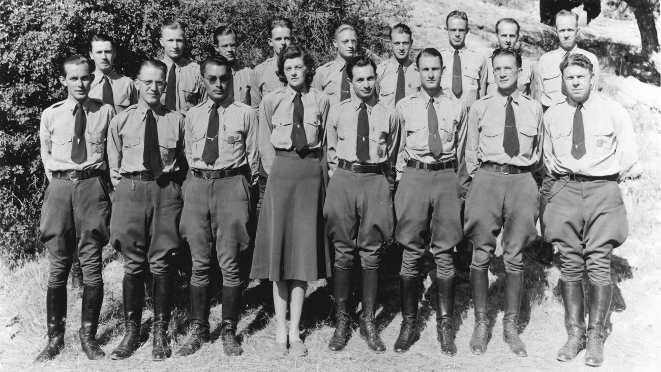 1942 J Pinkley Two rows of uniformed rangers stand shoulder to shoulder. The front center is a woman wearing a skirt while all the men wear breeches.