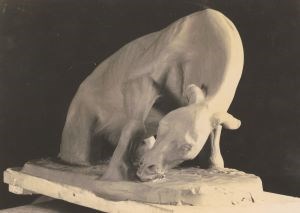 Clay model of a horse in progress. Animal’s head is bent toward the ground.