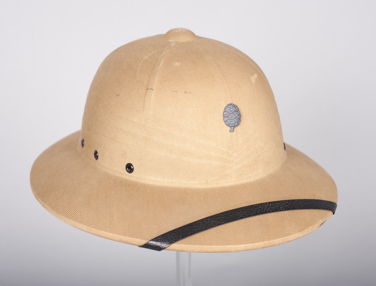 Tan pith helmet with a silver Sequoia cone on the front