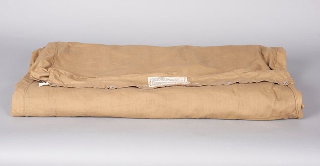 Mather's air mattress Folded khaki colored air mattress
