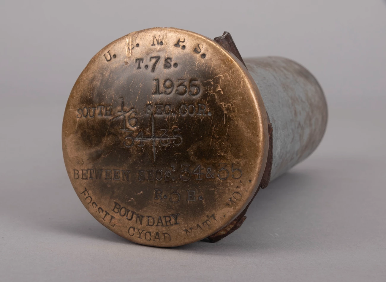 Bronze boundary marker Round bronze marker cap NPS and Fossil Cycad National Monument and 1935 date.