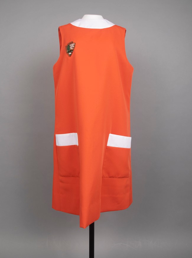 Pop-on Orange apron dress with white trim on a mannequin