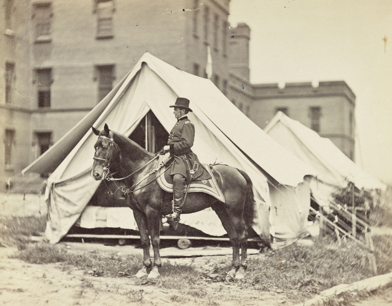 US Civil War military General Hooker on horseback in front of army tents.