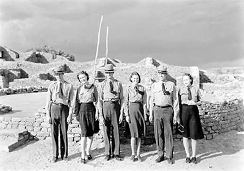 hpc 000052 Six uniformed rangers three men and three women stand among the ruins. The mind blows their ties and the ladies skirts.