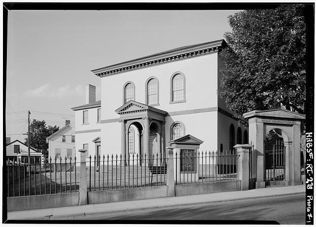 Teaching With Historic Places A large building behind a gated fence with a tree next to it