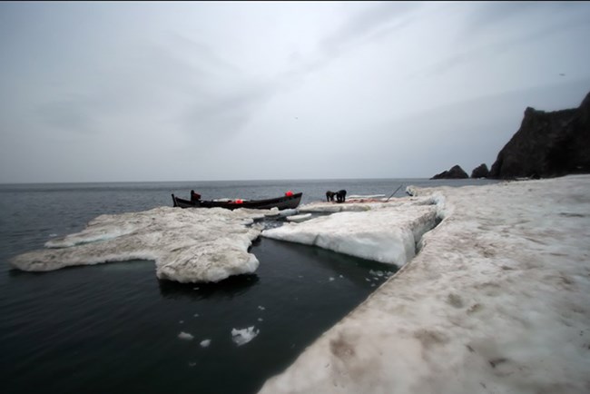 A boat pulled up to the ice edge.