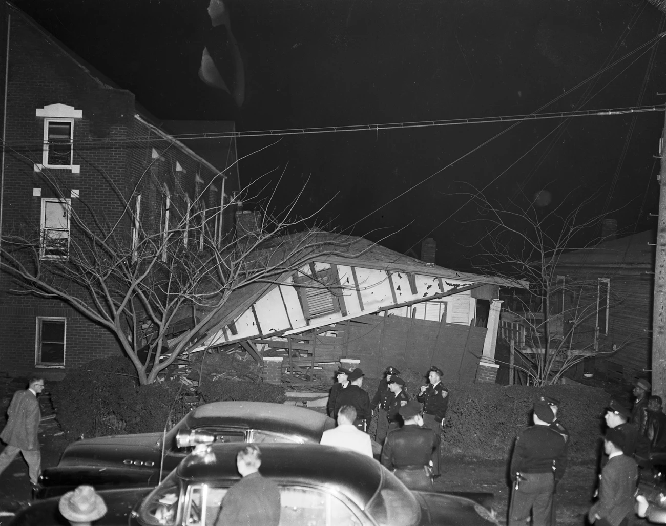 Bombing of Rev. Fred Shuttlesworth's house A black and white photo of police officers standing in front of a collapsed house