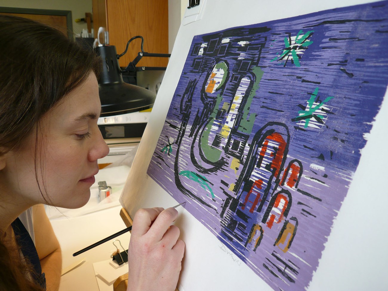 Artist White woman painting an abstract picture.
