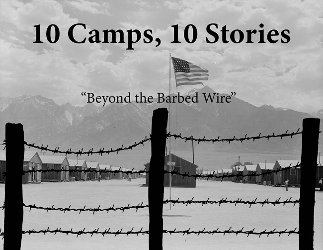 A barbed wire fence with an American flag in the background