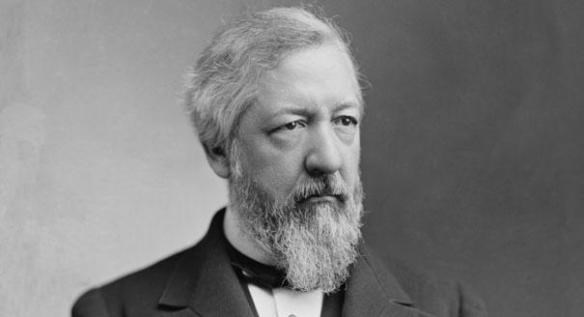 man with white hair and beard wearing a suit