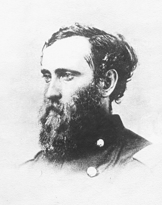 profile pick of a man in uniform who has a long dark beard