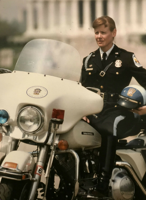 Kelcy Stefansson in uniform on her Harley Davidson motorcycle