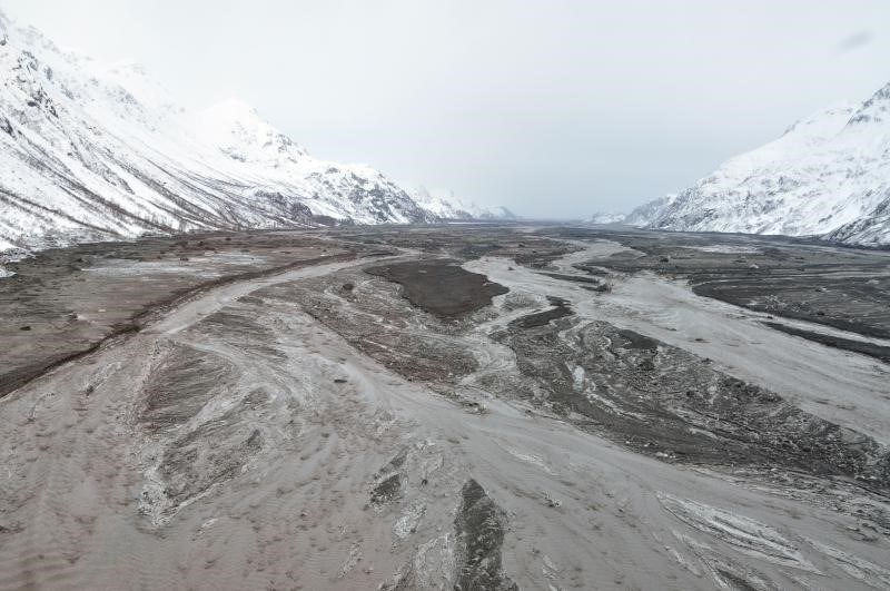 wide river bed with braided stream and sediment